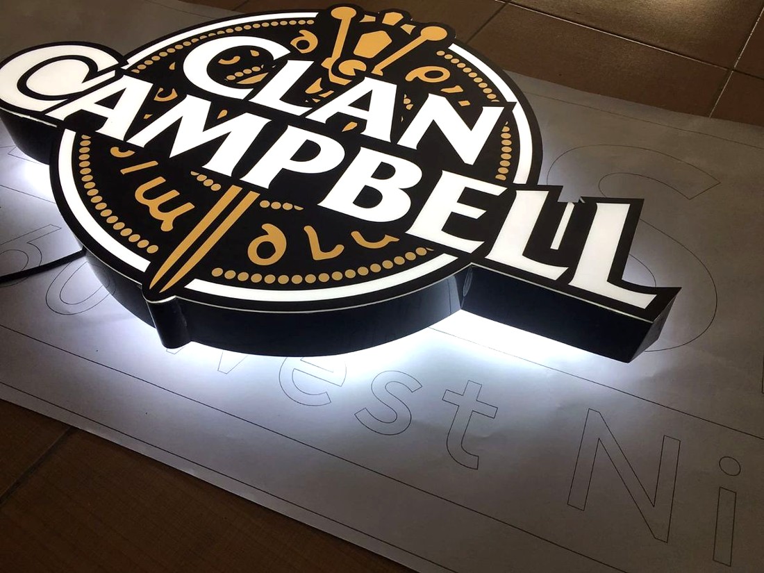 Illuminated Clan Campbell sign lying on a work surface